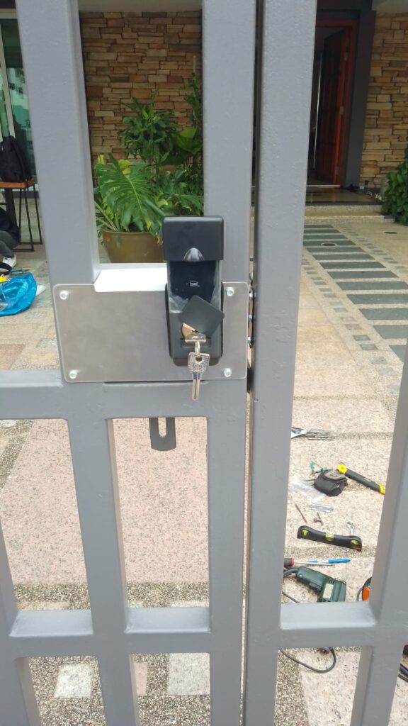 Battery-operated electric lock at the grill gate inside sliding auto-gate.